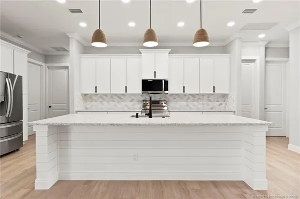 a large kitchen with stainless steel appliances kitchen island a large island in the center