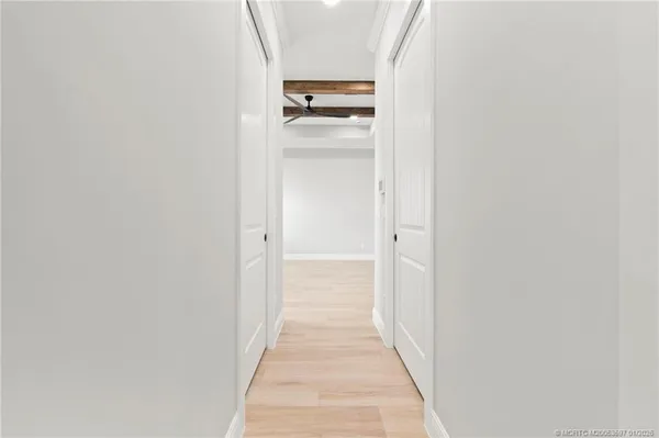 a view of a hallway with wooden floor