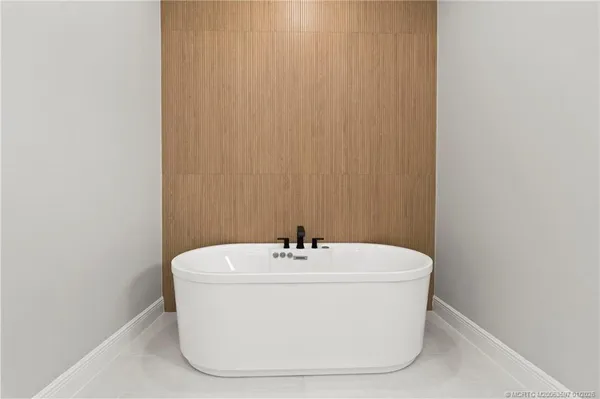 a white bath tub sitting in a bathroom