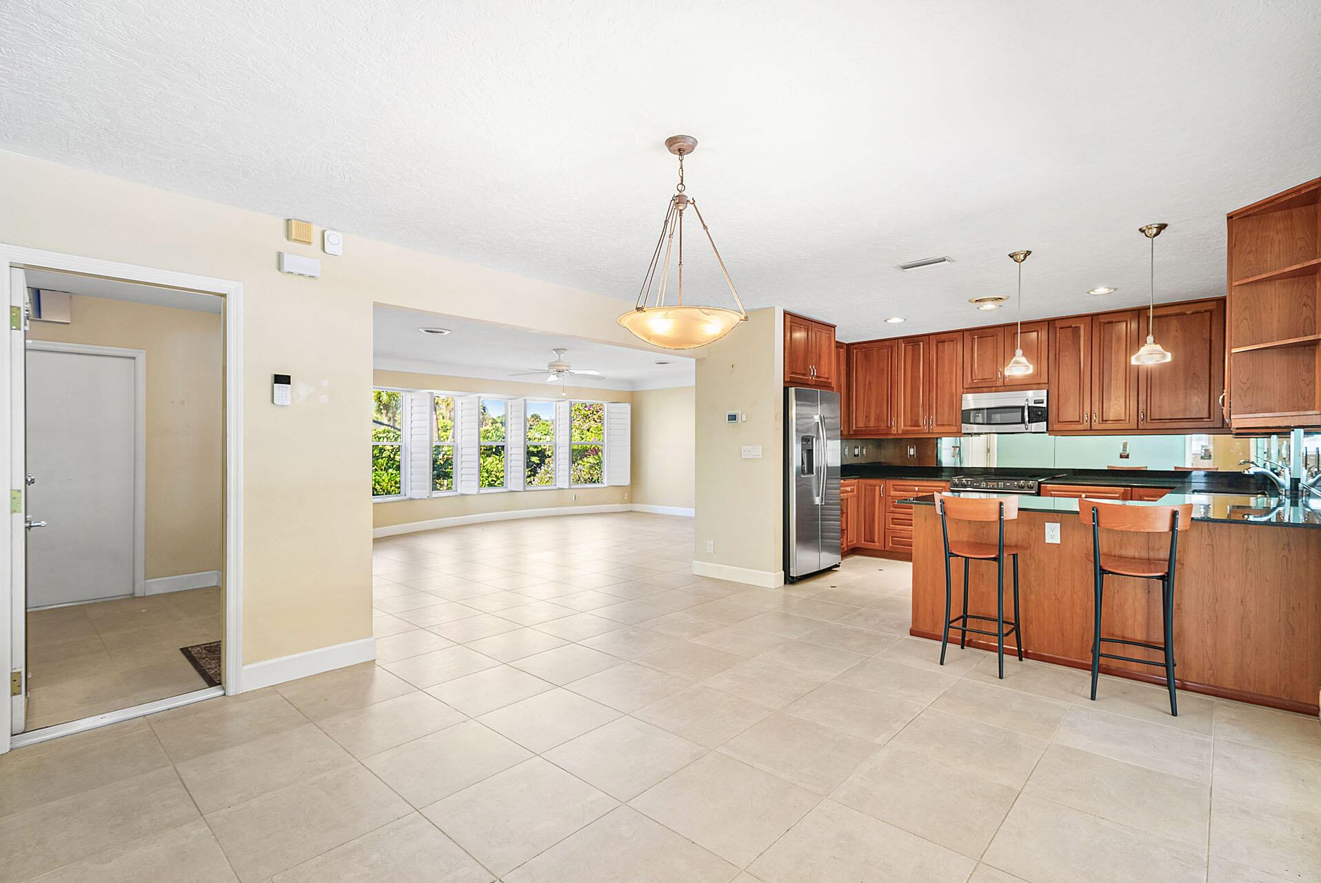 220 Southwest 9th Avenue Boca Raton, FL 33486 - Photo 12 of 42 a open kitchen with stainless steel appliances granite countertop a refrigerator and a sink