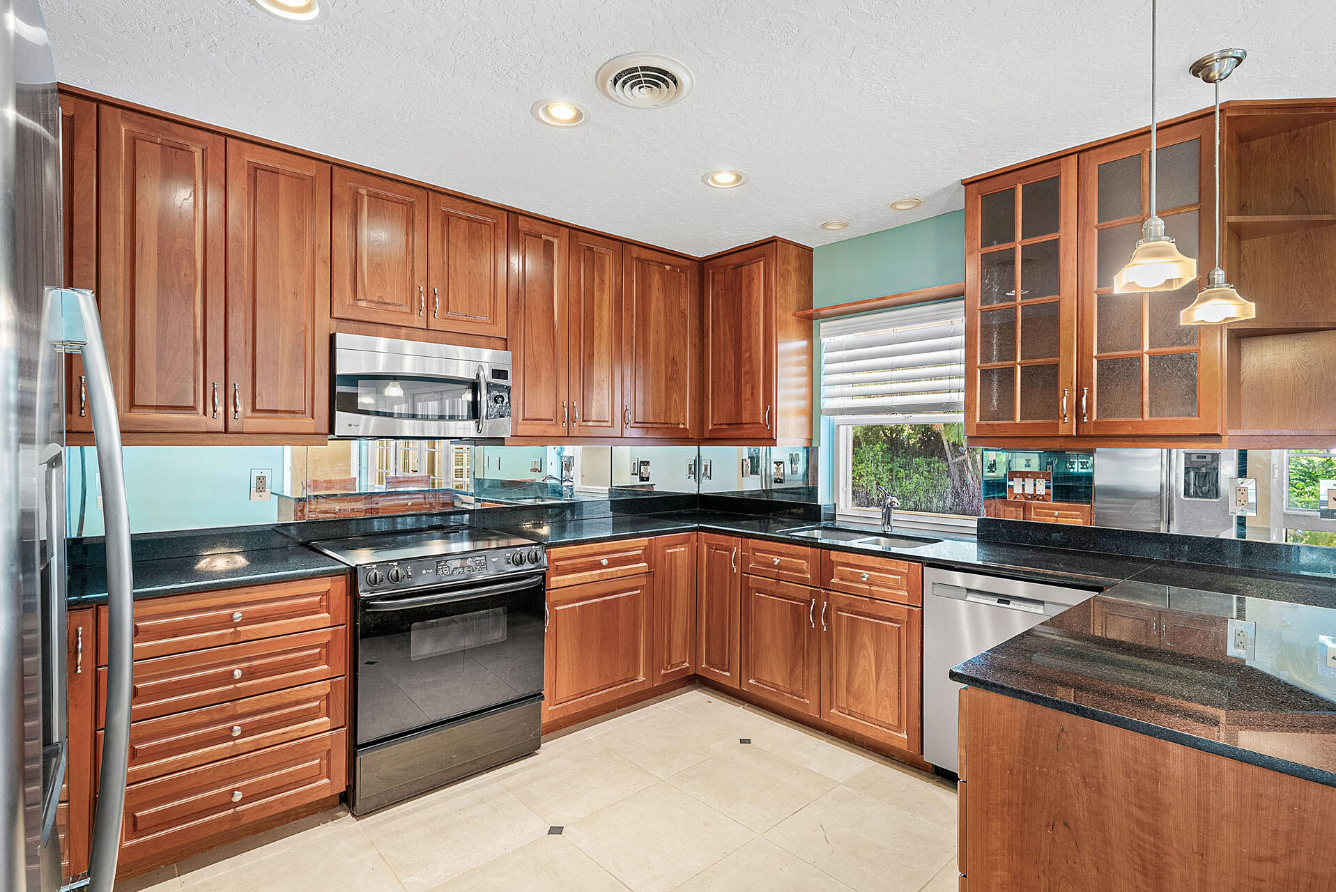 220 Southwest 9th Avenue Boca Raton, FL 33486 - Photo 14 of 42 a kitchen with stainless steel appliances granite countertop a stove sink and cabinets