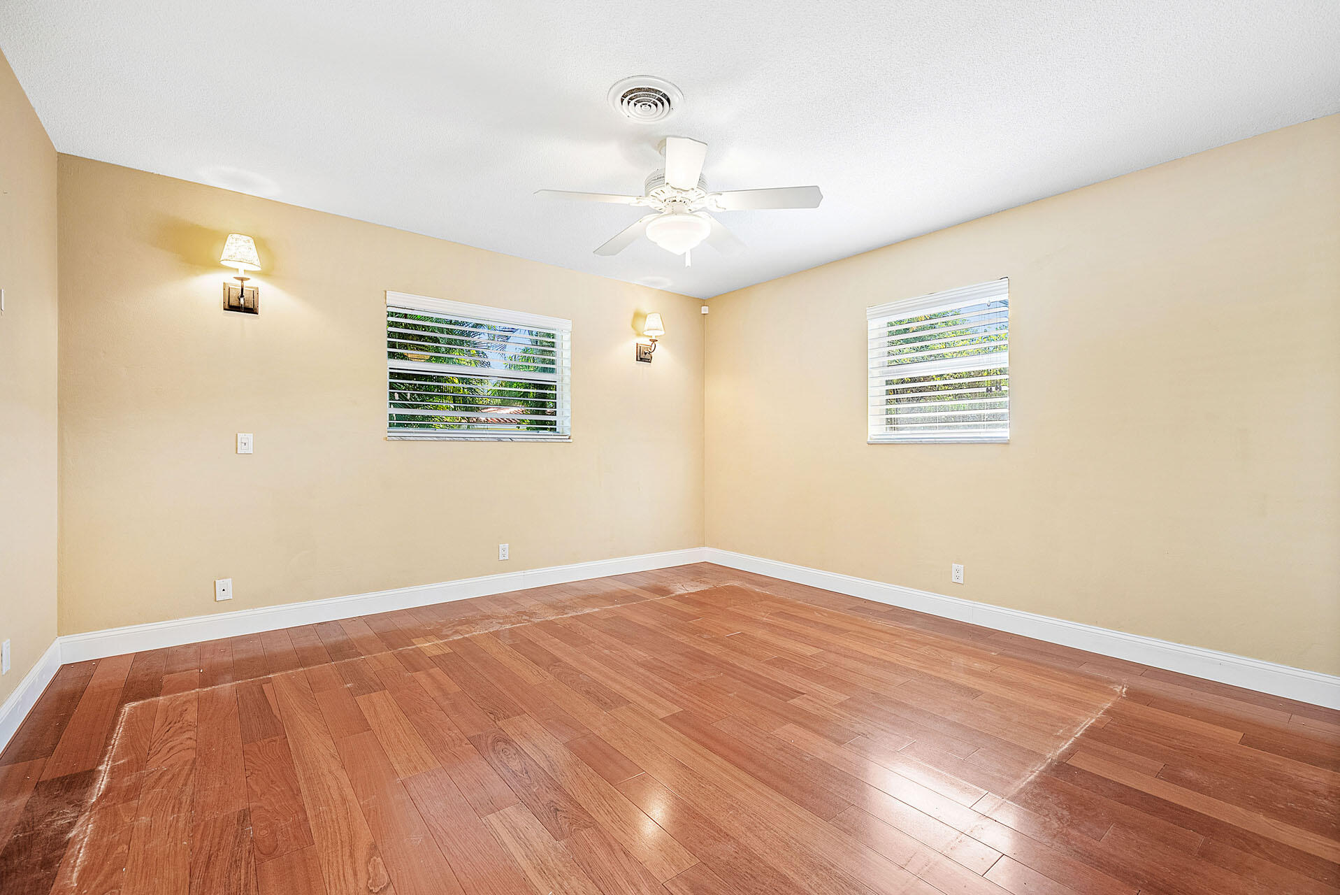 220 Southwest 9th Avenue Boca Raton, FL 33486 - Photo 25 of 42 a view of an empty room with wooden floor and a window