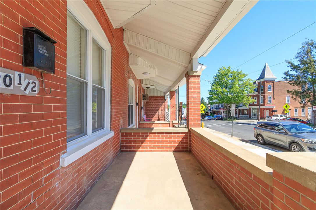 820 North 5th Street Allentown, PA 18102 - Photo 11 of 39 A classic brick facade offers a welcoming covered porch, perfect for enjoying neighborhood views.