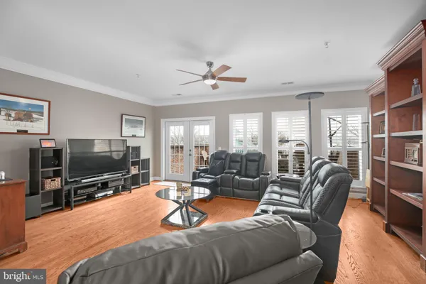 a living room with furniture and a flat screen tv with wooden floor