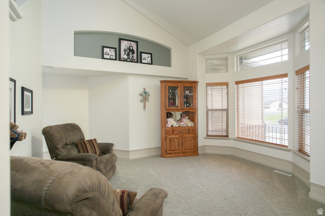426 Deer Hollow Road Tooele, UT 84074 - Photo 2 of 37 Living area with light colored carpet and high vaulted ceiling