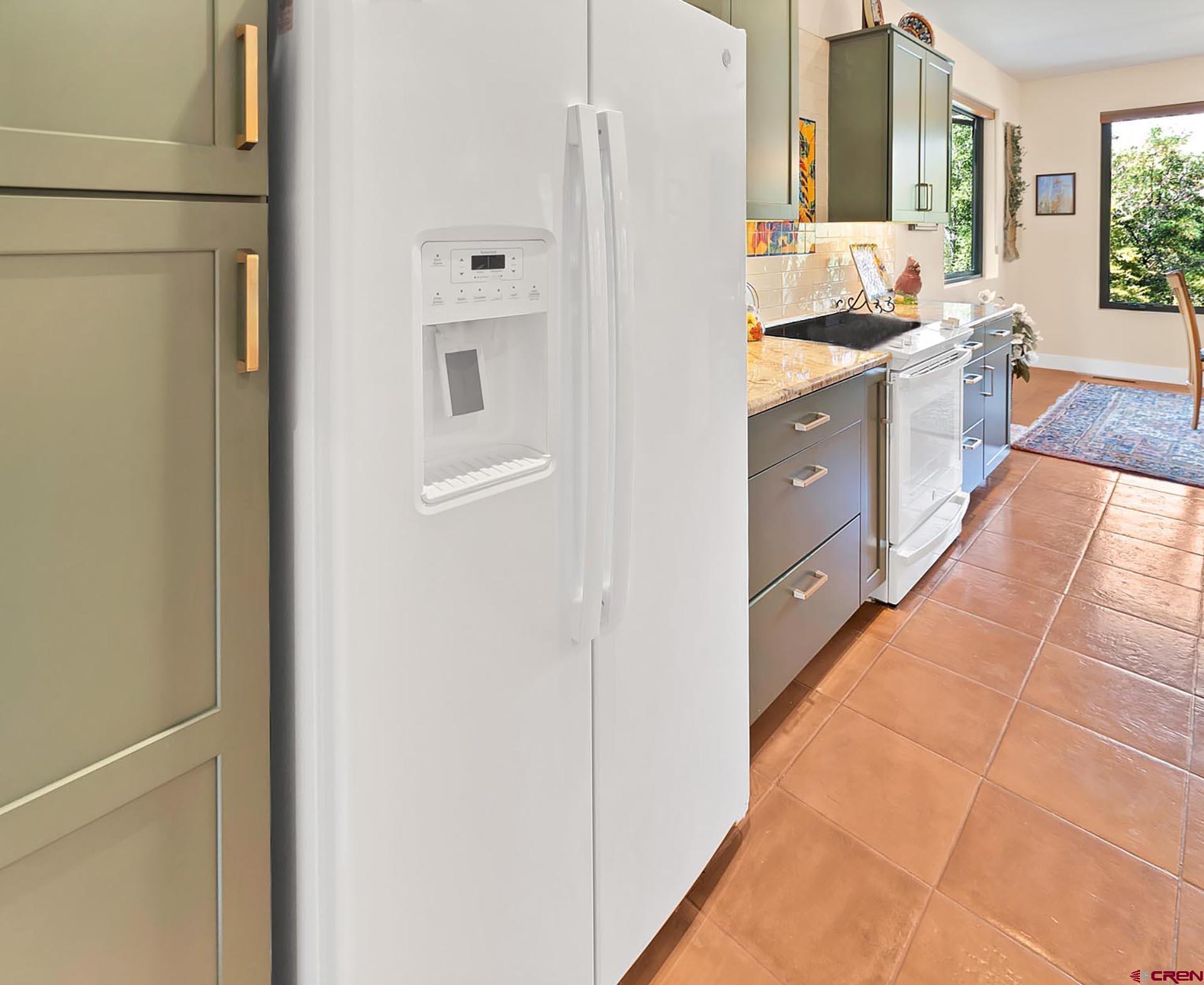 1470 Southeast Stonebridge Drive Cedaredge, CO 81413 - Photo 14 of 42 a large white kitchen with granite countertop a sink and dishwasher a refrigerator with wooden floor