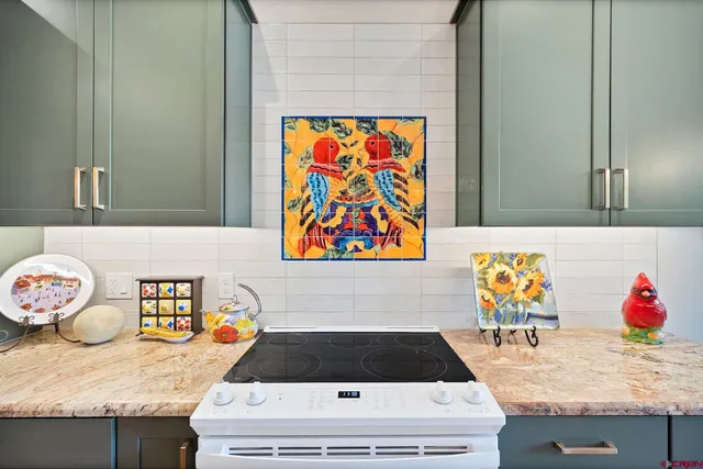 a bathroom with a sink a mirror and painting on the wall