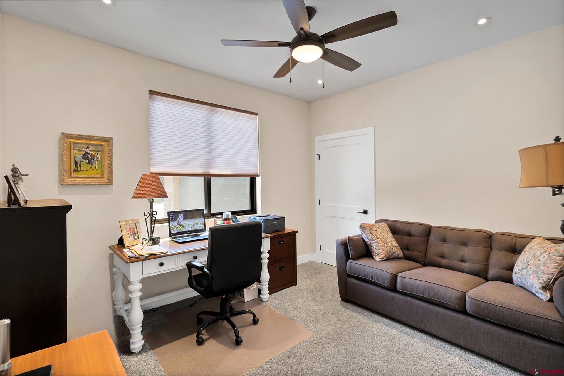 1470 Southeast Stonebridge Drive Cedaredge, CO 81413 - Photo 20 of 42 a livingroom with workspace couch and a window