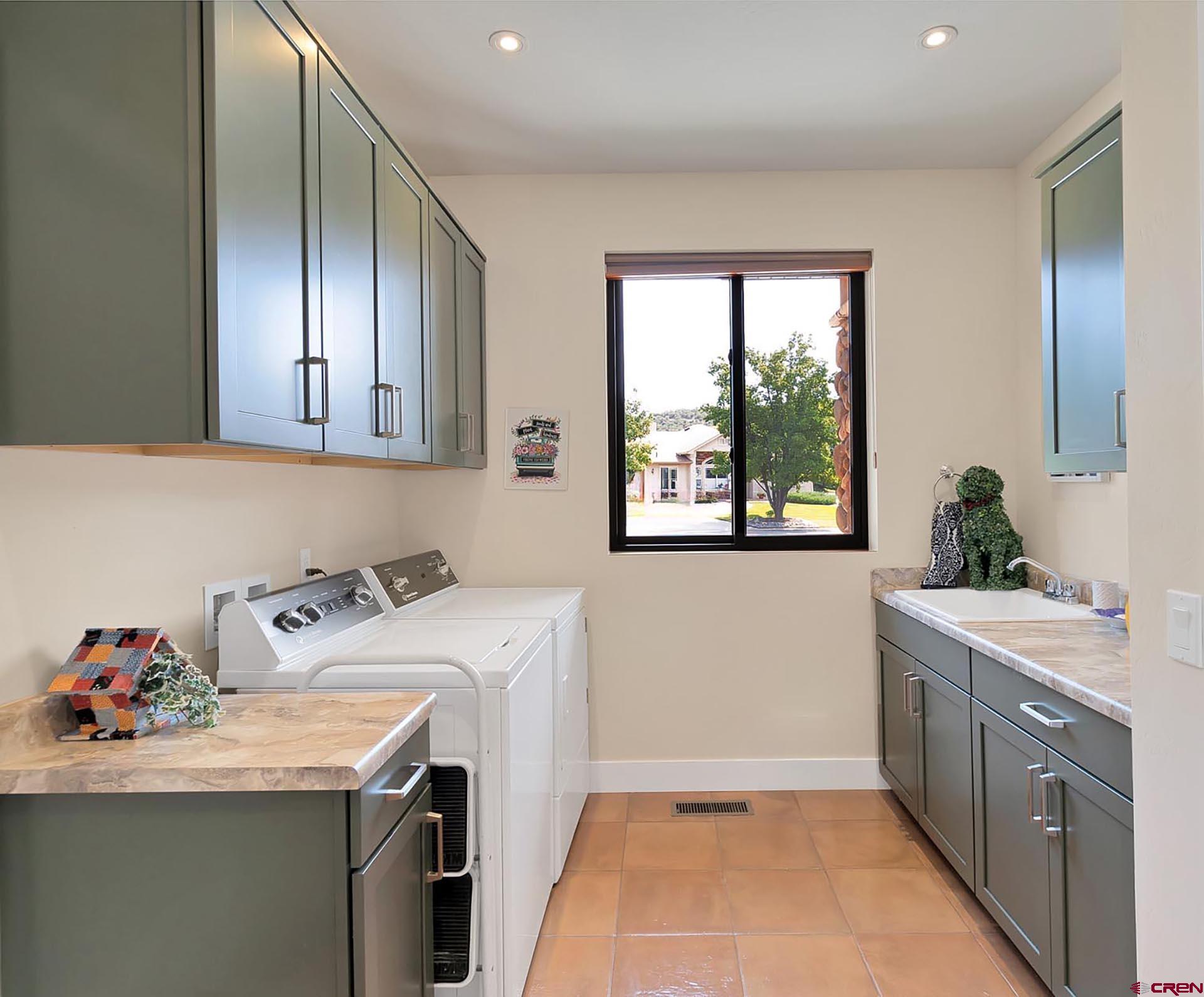 1470 Southeast Stonebridge Drive Cedaredge, CO 81413 - Photo 21 of 42 a utility room with sink dryer and washer