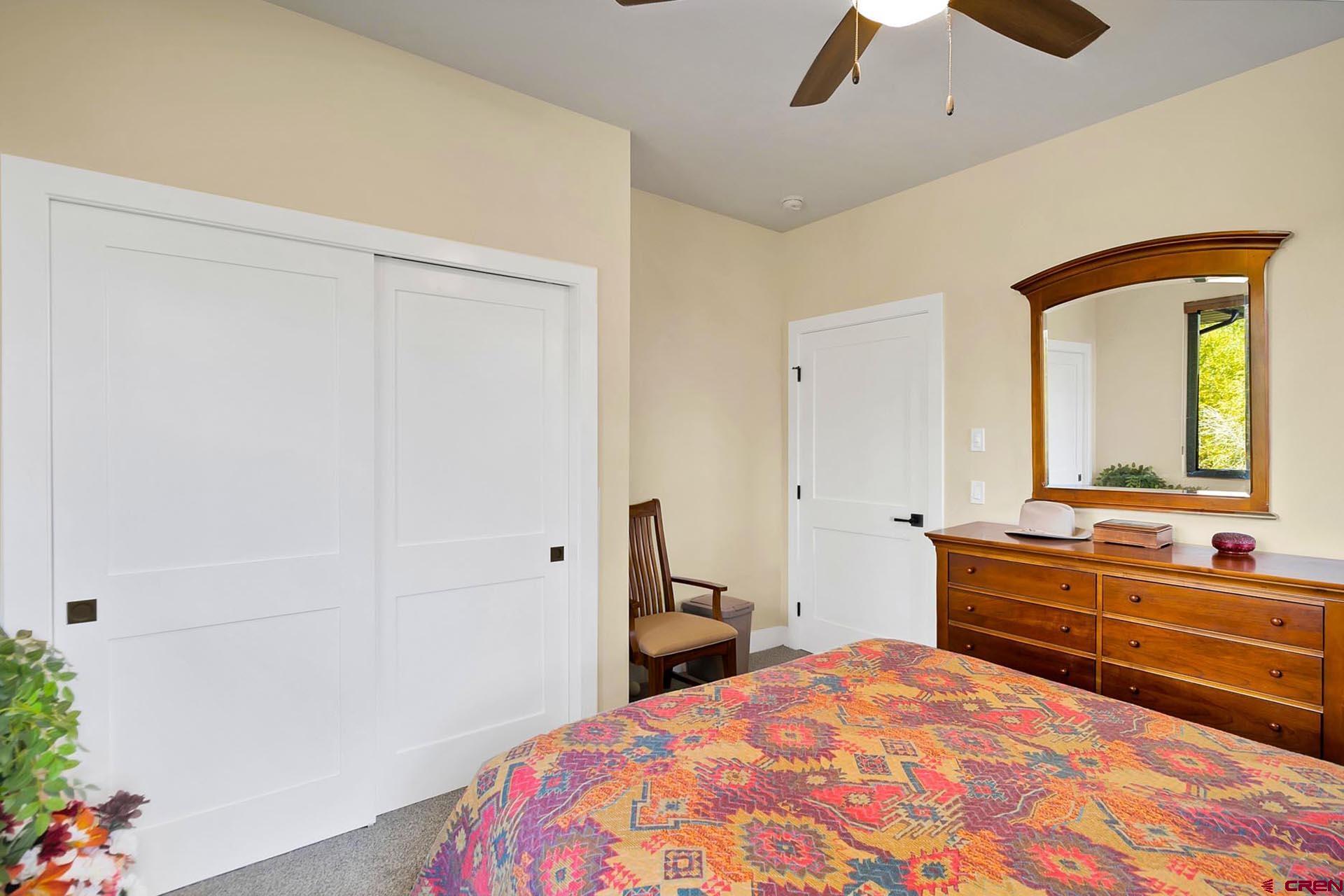 1470 Southeast Stonebridge Drive Cedaredge, CO 81413 - Photo 23 of 42 a bedroom with a bed and a closet