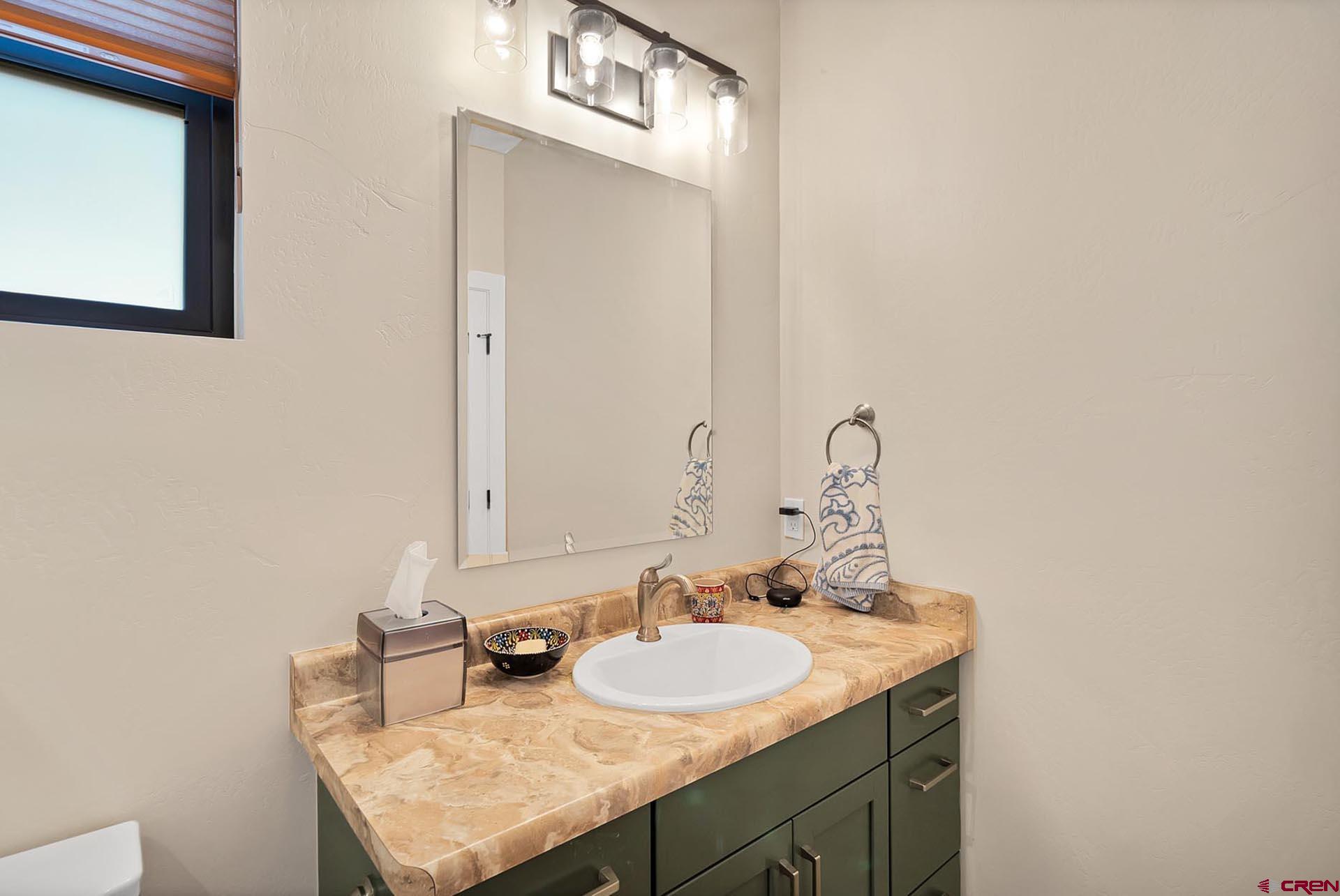 1470 Southeast Stonebridge Drive Cedaredge, CO 81413 - Photo 25 of 42 a bathroom with a sink and a mirror