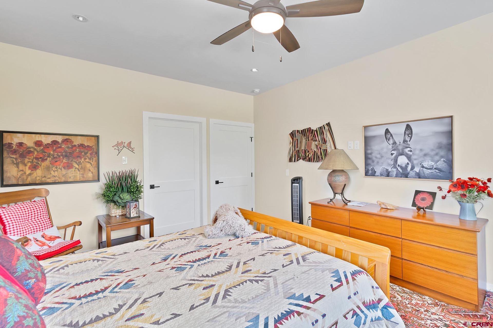 1470 Southeast Stonebridge Drive Cedaredge, CO 81413 - Photo 30 of 42 a bedroom with a large bed and a chandelier