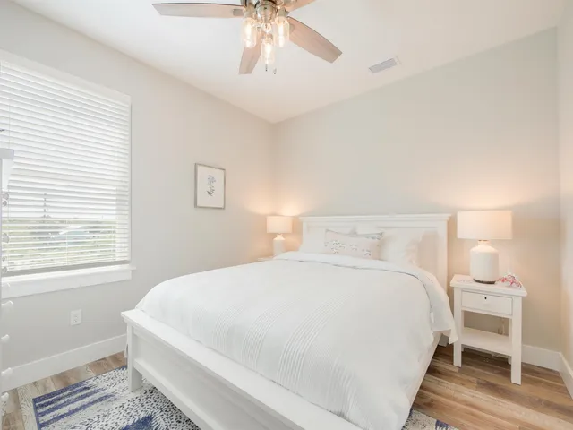 a bathroom with a granite countertop sink a large mirror and a shower