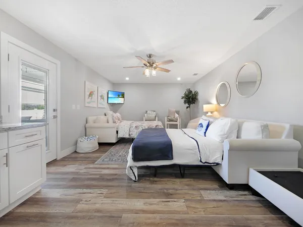 a spacious bedroom with two beds and a couch