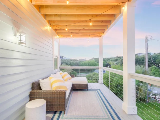 a view of a balcony with couch and wooden floor