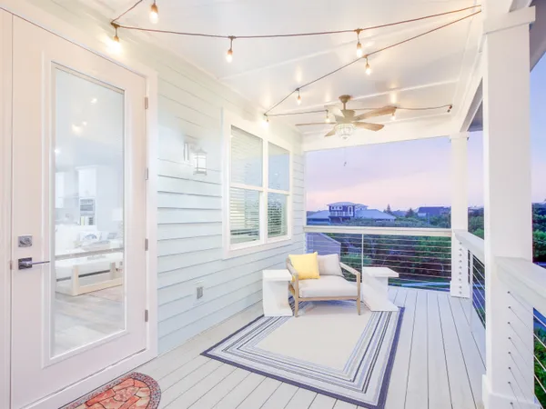 a view of balcony with wooden floor and outdoor seating