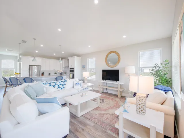 a living room with furniture a fireplace and a table