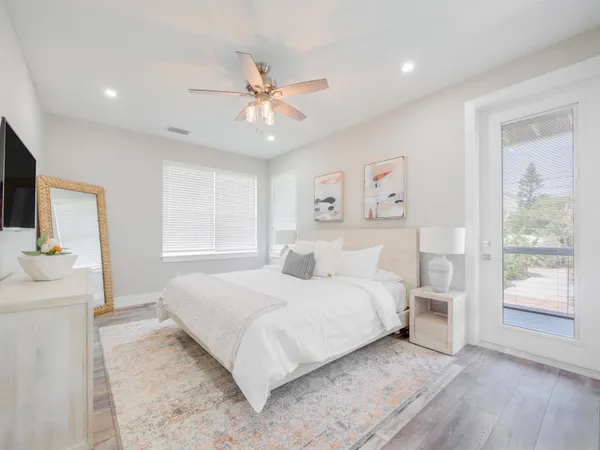 a bedroom with a large bed and a window