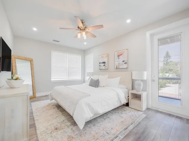 a bedroom with a large bed and a window