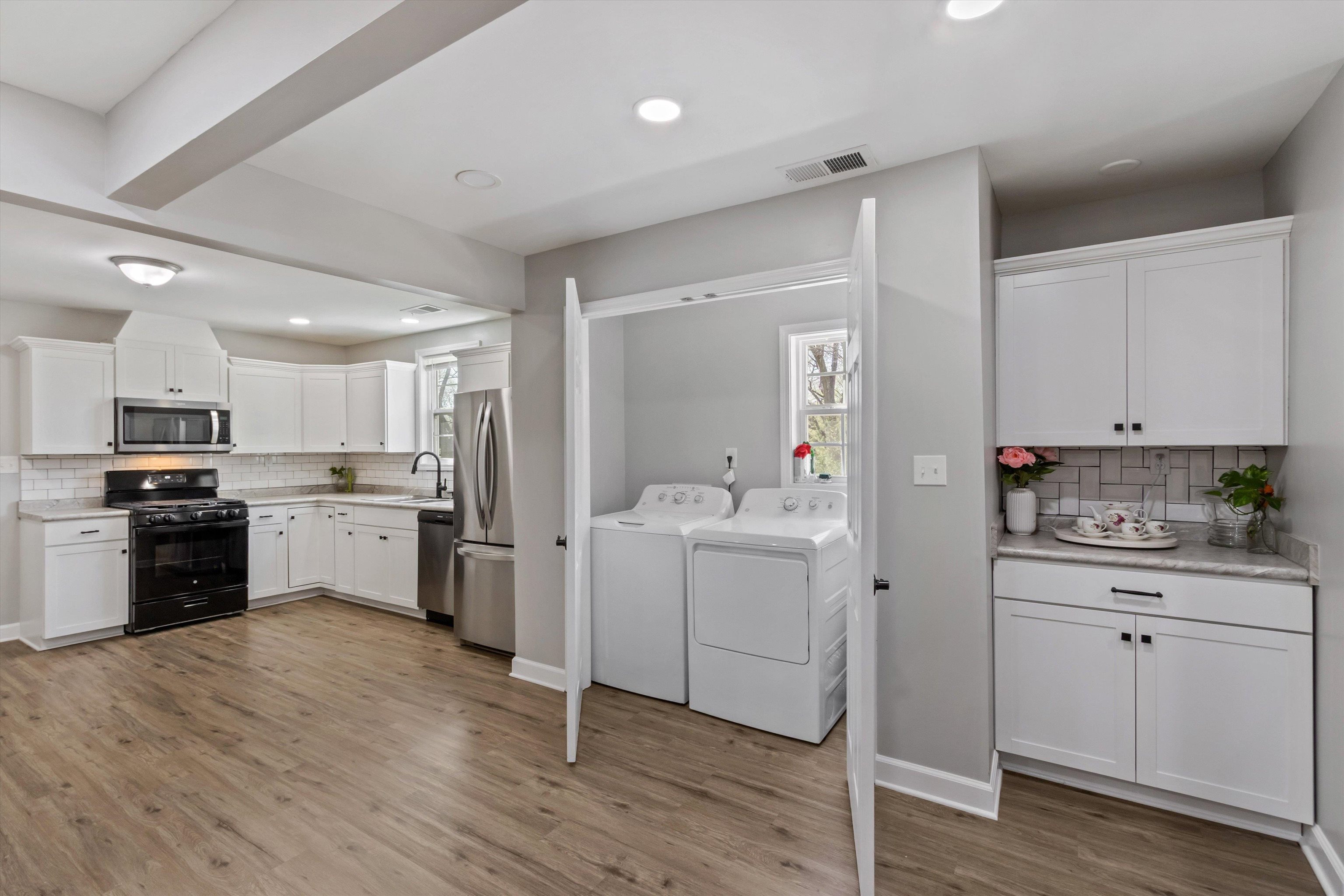 1217 Carlton Road Memphis, TN 38106 - Photo 12 of 32 Laundry area with washing machine and dryer, light wood-style flooring, and recessed lighting