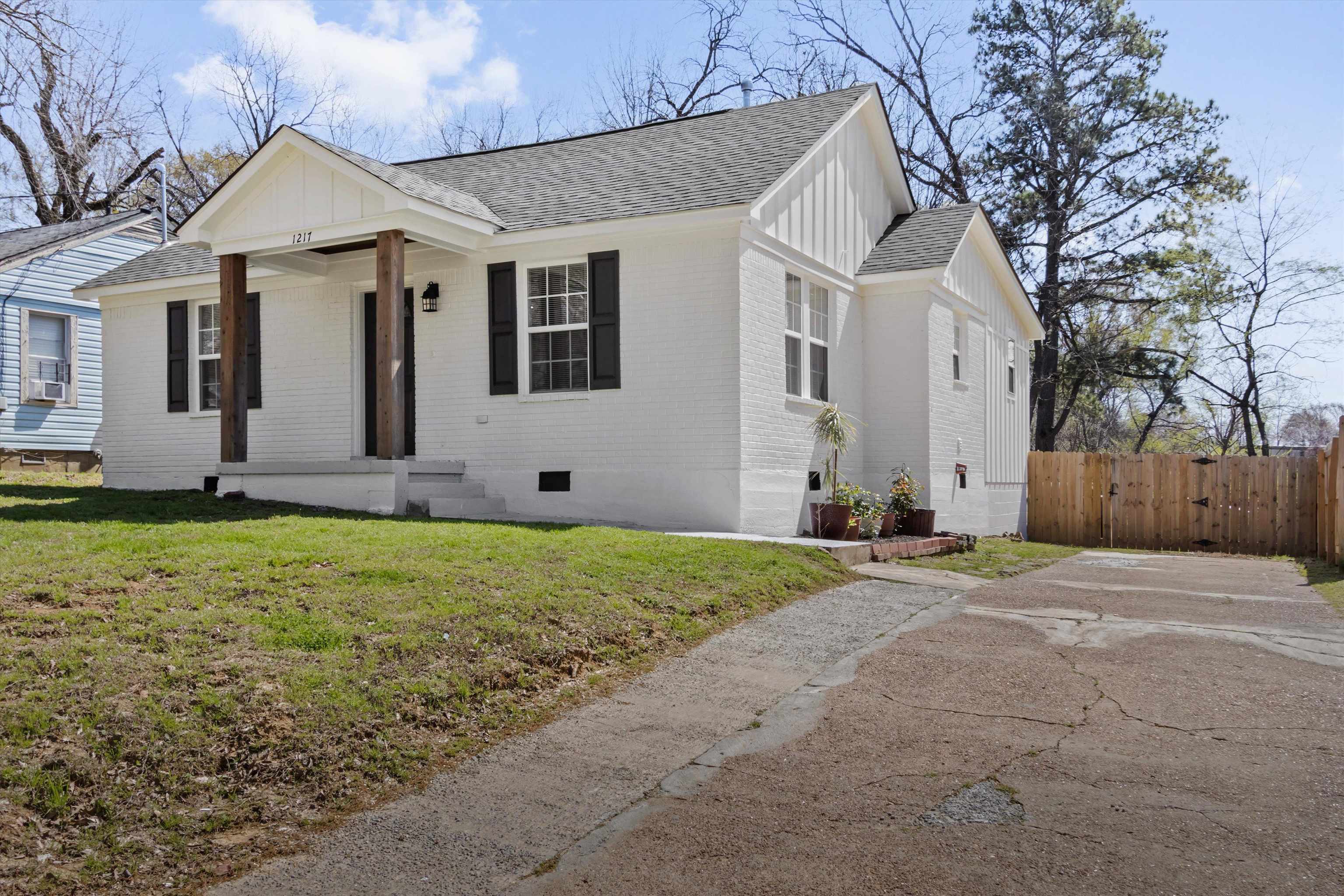 1217 Carlton Road Memphis, TN 38106 - Photo 2 of 32 Modern farmhouse with roof with shingles, brick siding, crawl space, a front yard, and board and batten siding