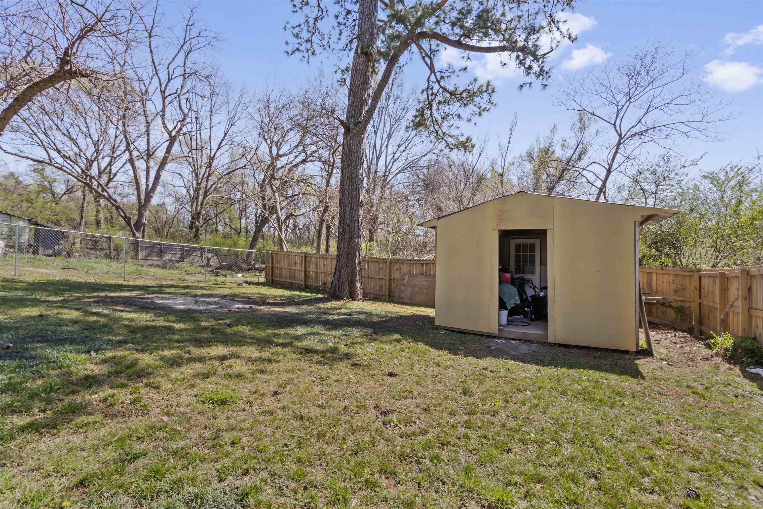 1217 Carlton Road Memphis, TN 38106 - Photo 25 of 32 Fenced backyard with a storage shed