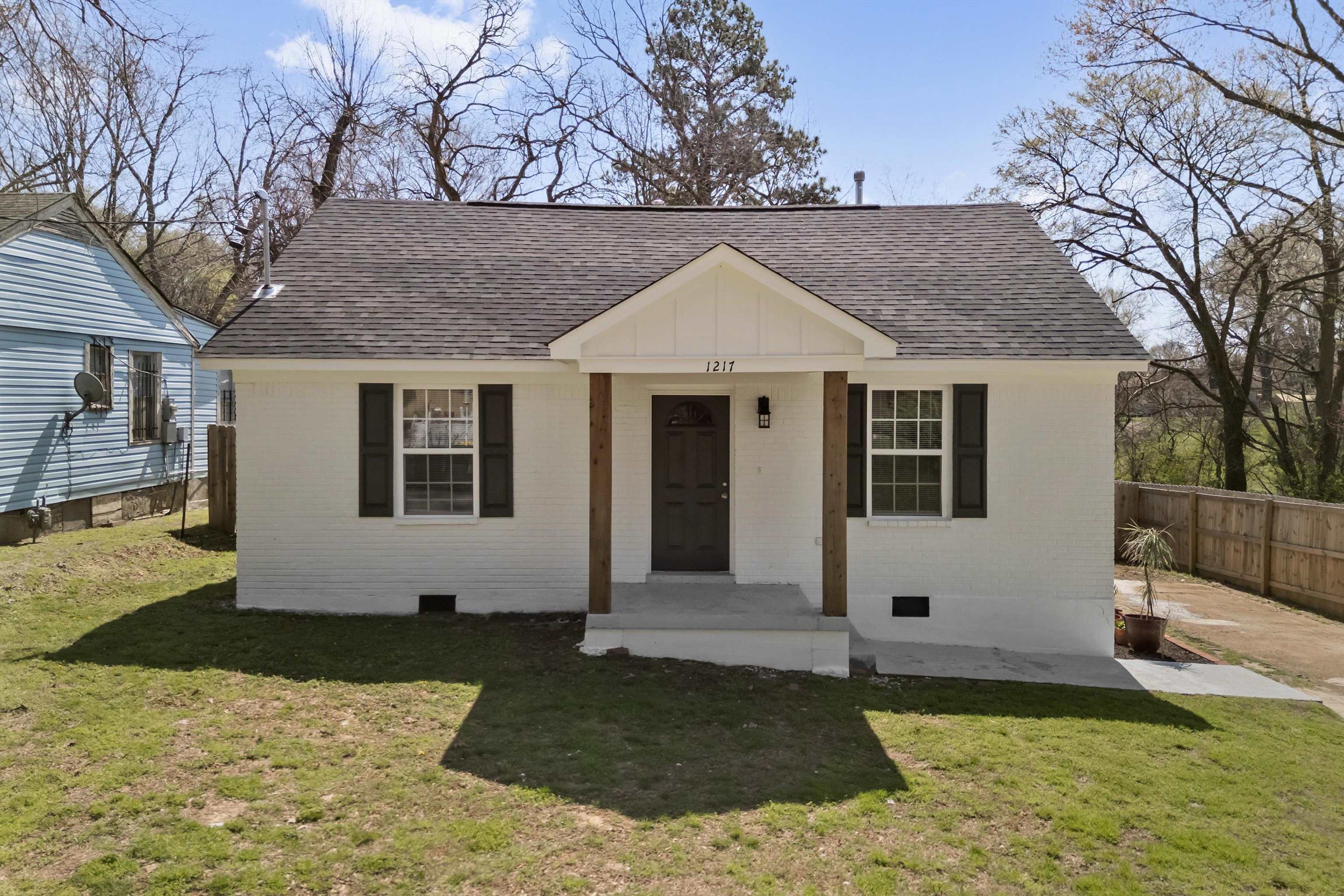 1217 Carlton Road Memphis, TN 38106 - Photo 26 of 32 View of front of home featuring a shingled roof, crawl space, brick siding, and covered porch