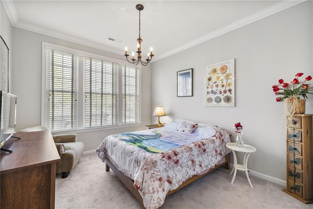 140 Independence Way Sewickley, PA 15143 - Photo 18 of 33 a bedroom with a bed chandelier and a window