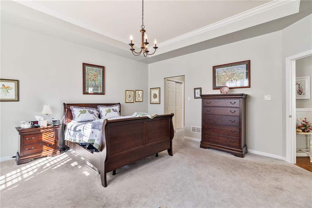 140 Independence Way Sewickley, PA 15143 - Photo 22 of 33 a spacious bedroom with a bed and a chandelier