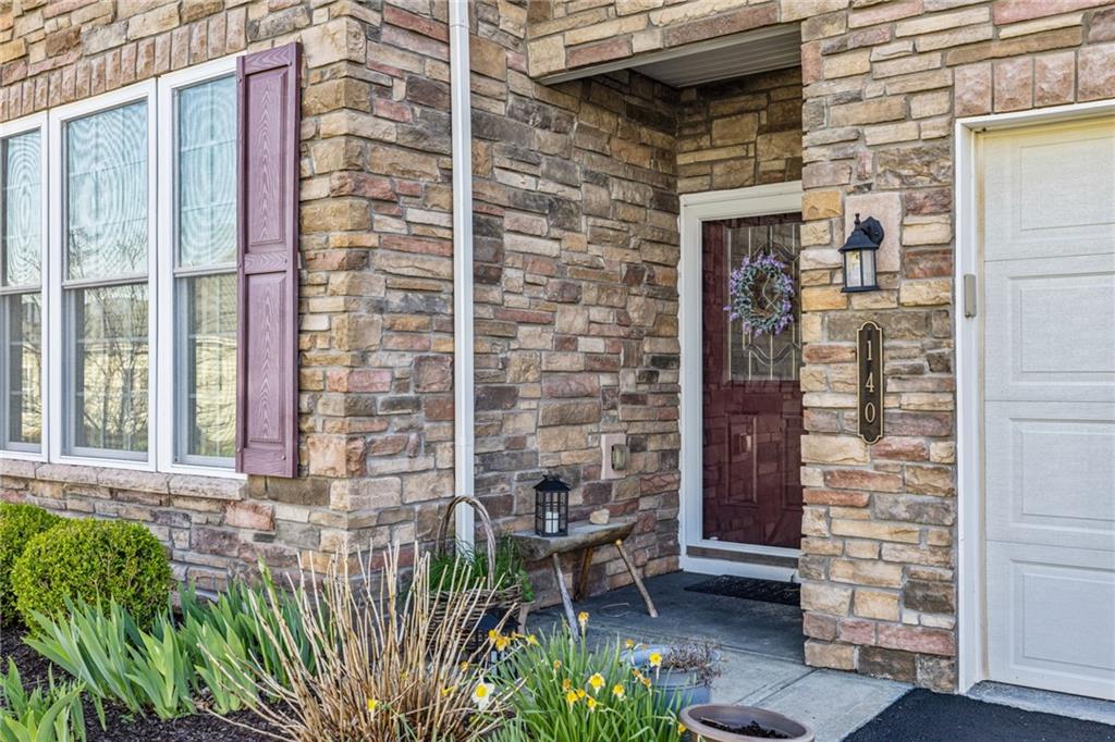 140 Independence Way Sewickley, PA 15143 - Photo 3 of 33 a brick building with a bench and potted plant
