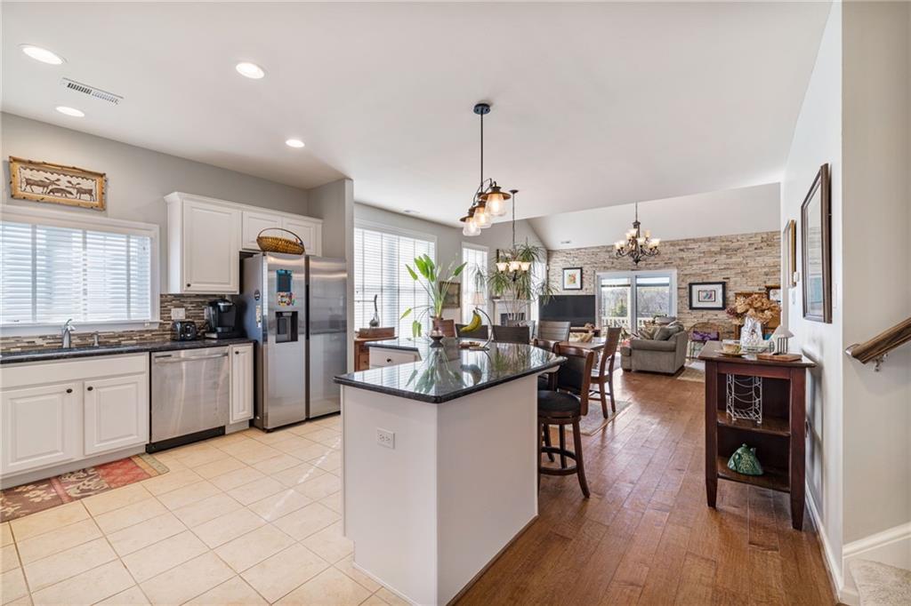 140 Independence Way Sewickley, PA 15143 - Photo 6 of 33 a kitchen with stainless steel appliances kitchen island granite countertop a stove and cabinets