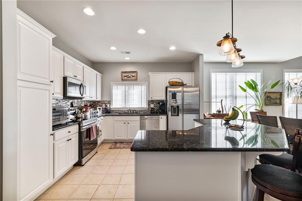 140 Independence Way Sewickley, PA 15143 - Photo 8 of 33 a kitchen with stainless steel appliances granite countertop a sink a stove and refrigerator