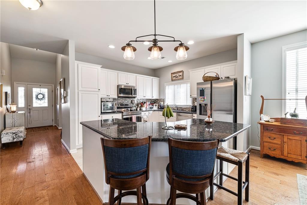 140 Independence Way Sewickley, PA 15143 - Photo 9 of 33 a kitchen with sink a refrigerator and chairs