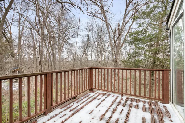 a view of balcony with wooden floor and fence