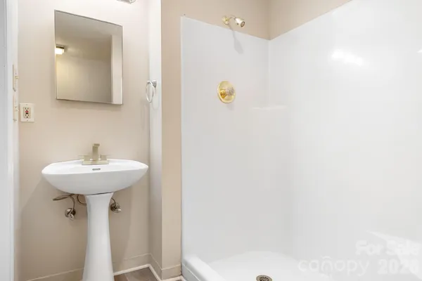 a bathroom with a sink a mirror and a toilet