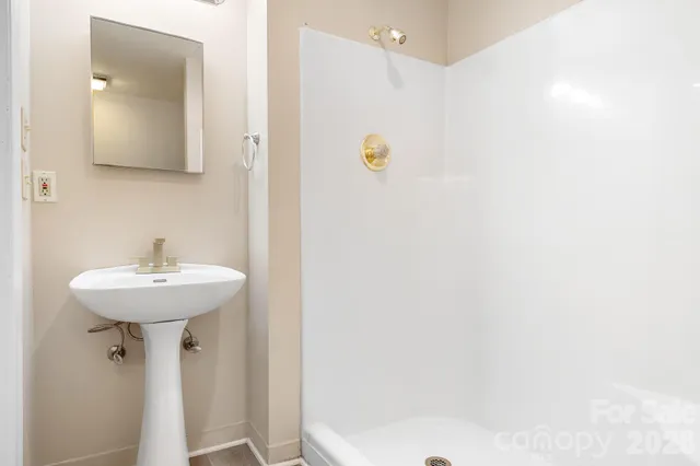 a bathroom with a sink a mirror and a toilet