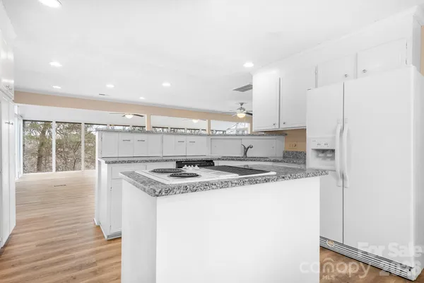 a kitchen with stainless steel appliances granite countertop a sink stove and cabinets