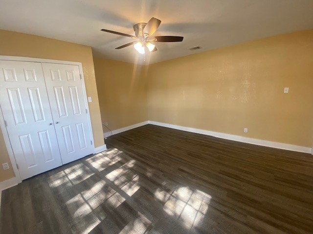 214 South Hackberry Avenue Luling, TX 78648 - Photo 15 of 22 a view of an empty room with wooden floor and fan