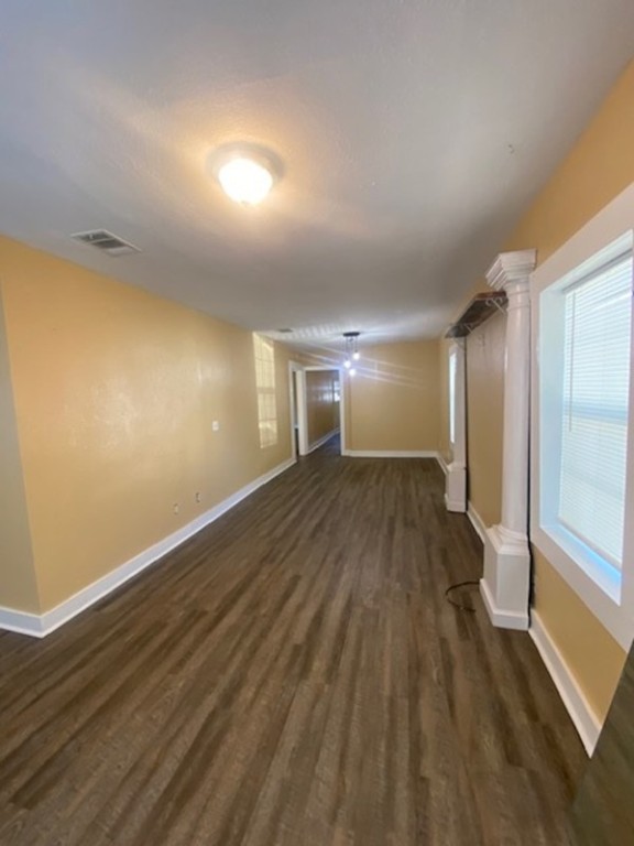 214 South Hackberry Avenue Luling, TX 78648 - Photo 16 of 22 a view of empty room with wooden floor