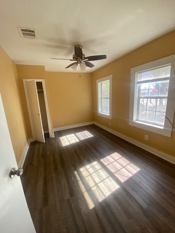 214 South Hackberry Avenue Luling, TX 78648 - Photo 19 of 22 Spare room with dark wood-type flooring and ceiling fan
