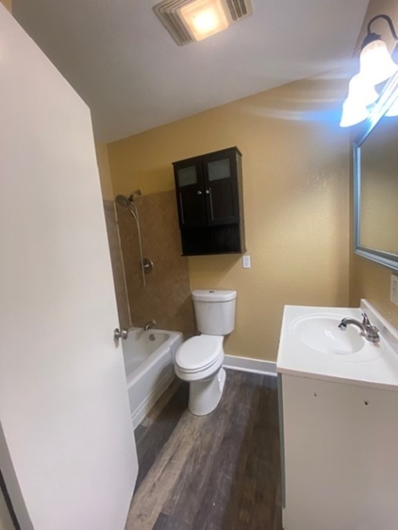 214 South Hackberry Avenue Luling, TX 78648 - Photo 21 of 22 a bathroom with a toilet a sink and mirror