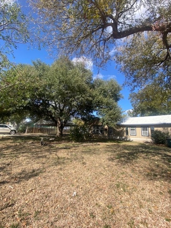 214 South Hackberry Avenue Luling, TX 78648 - Photo 4 of 22 a view of a yard with large trees
