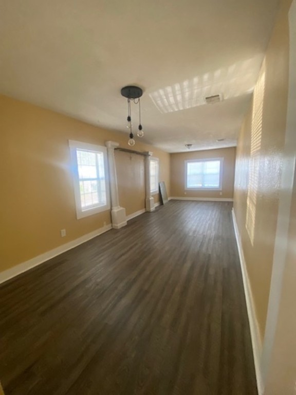 214 South Hackberry Avenue Luling, TX 78648 - Photo 9 of 22 wooden floor in an empty room with a window
