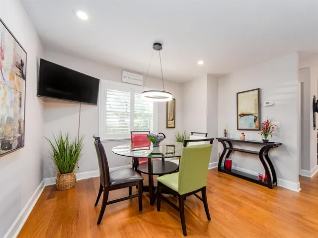 a view of a dining room with furniture and a potted plant