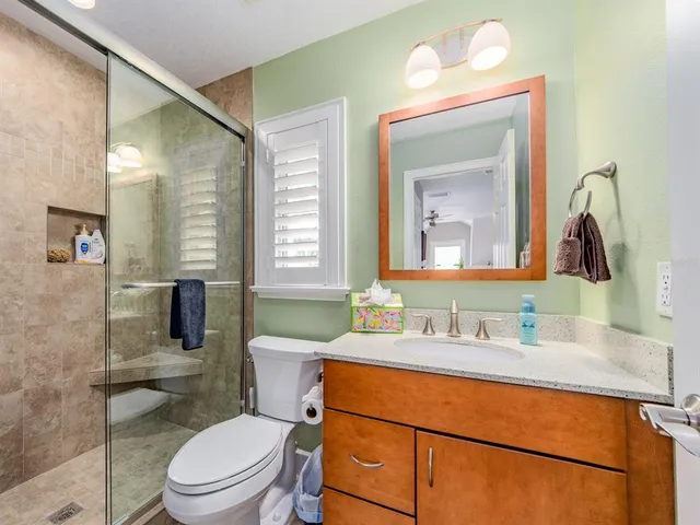 a bathroom with a toilet a sink and mirror