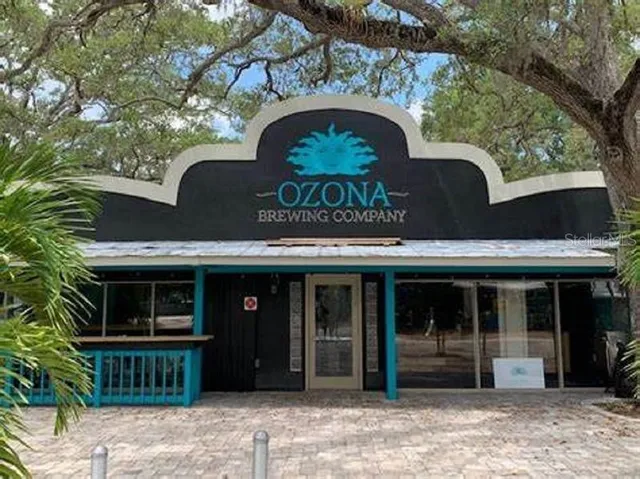 a view of a patio with dining table and chairs under an umbrella