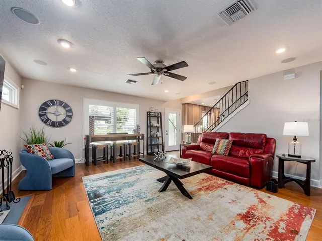 a living room with furniture ceiling fan and a rug