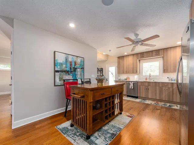 a room with lots of wooden furniture and a chandelier