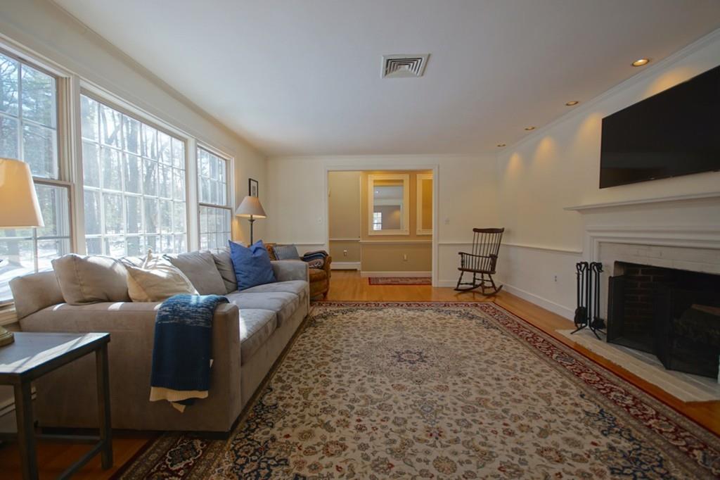 19 Towne Road Boxford, MA 01921 - Photo 8 of 39 a living room with furniture a flat screen tv and a fireplace