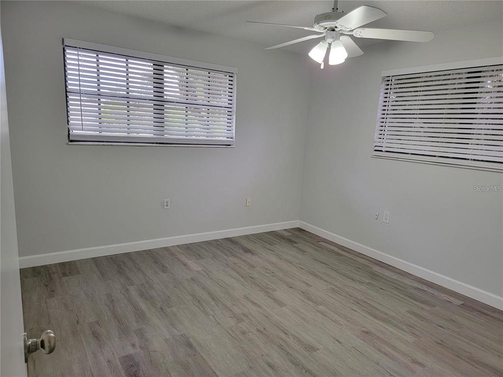 26221 Constantine Road Punta Gorda, FL 33983 - Photo 22 of 27 a view of an empty room with wooden floor and a window